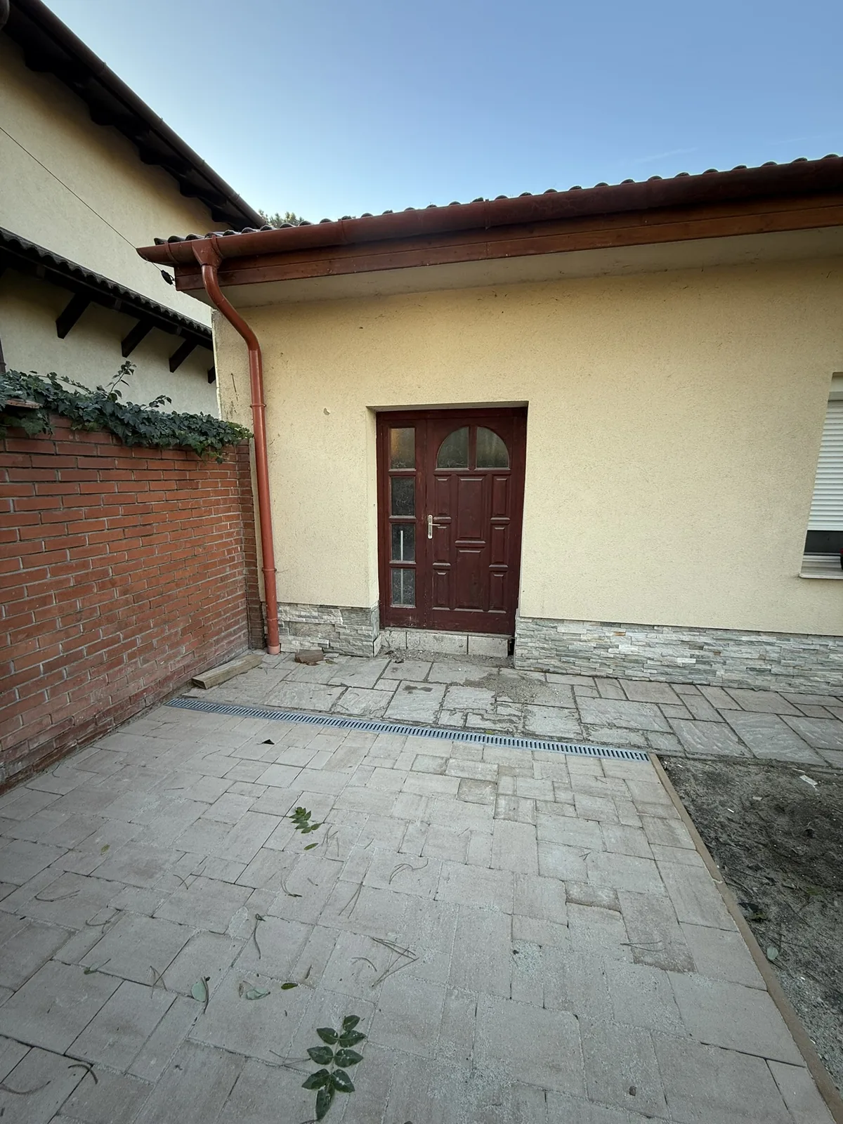 Térkövezett udvar kőlábazattal